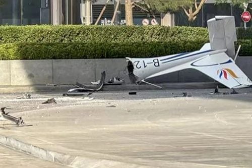 Debris from the aircraft and shattered glass scattered down the streets below the CITIC Tower after the impact in central Beijing. PHOTO/@fl360aero/X