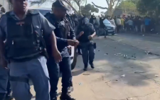 Migrants clash with police at deportation site in South Africa where thousands have gathered