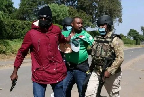 Police officers in Nanyuki arrest a local resident during Tuesday’s protests against the proposed Ebola quarantine facility. PHOTO/Wanjira Wachira