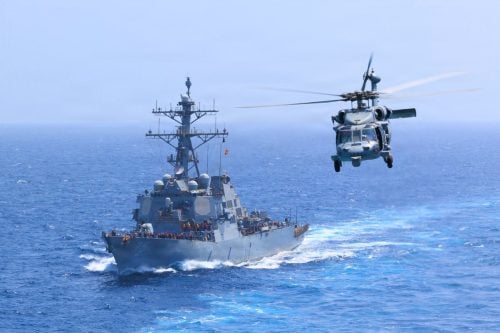 USS Donald Cook (DDG 75) transits the Arabian Sea alongside an MH-60S Sea Hawk helicopter as US forces enforce a naval blockade against Iran. PHOTO/@CENTCOM/X